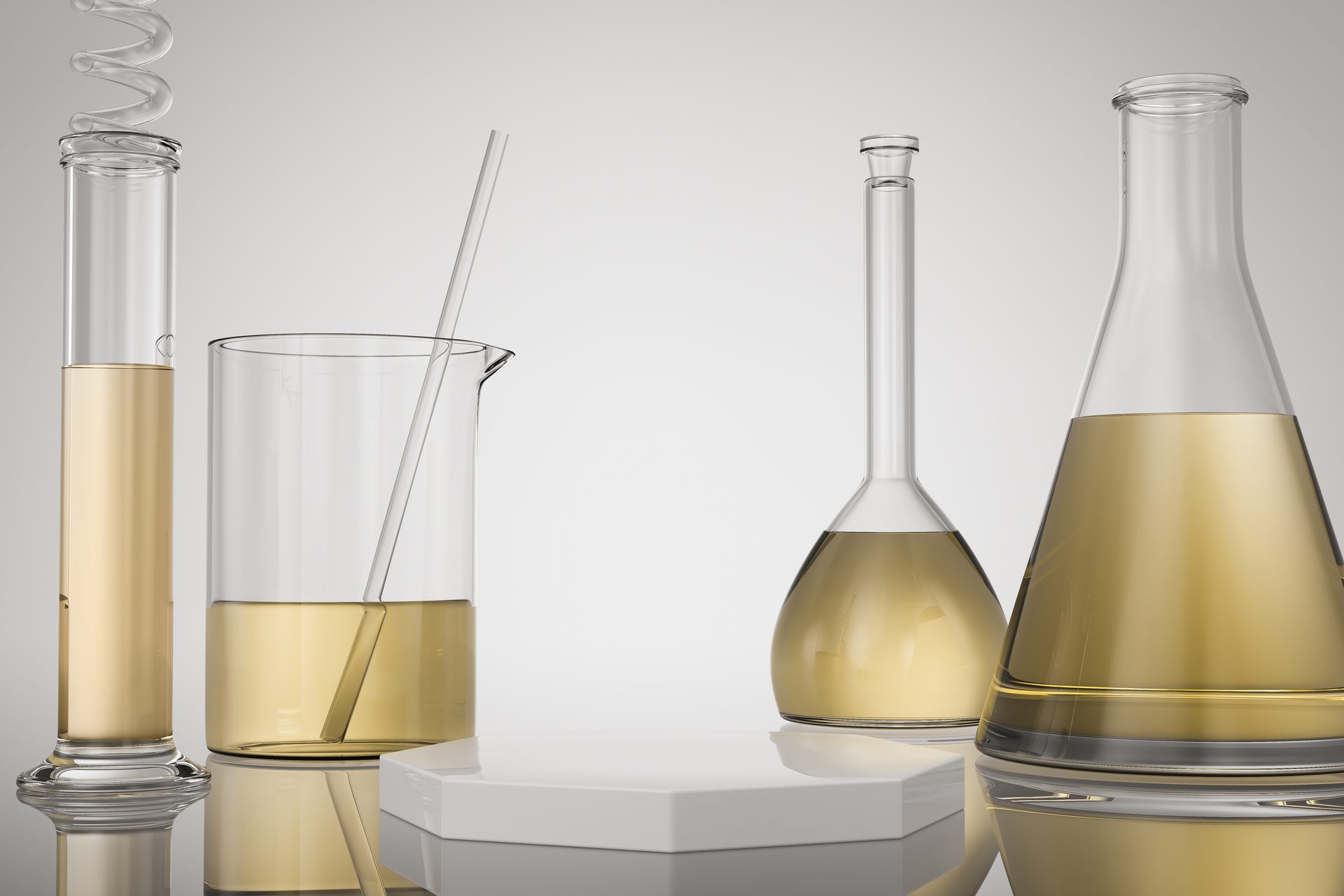 Glass cylinder, beaker, volumetric flask and conical flask holding pale yellow liquid on grey